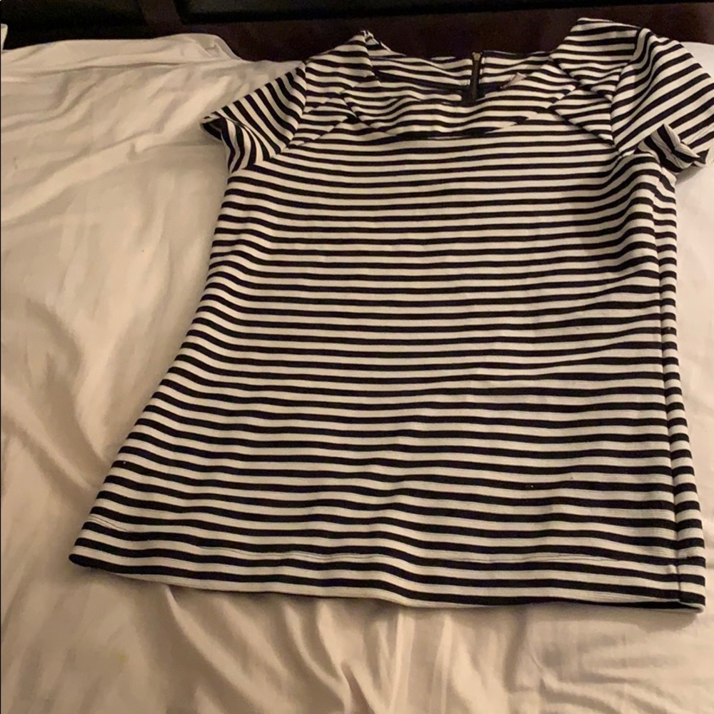 A black and white striped shirt, blue leggings